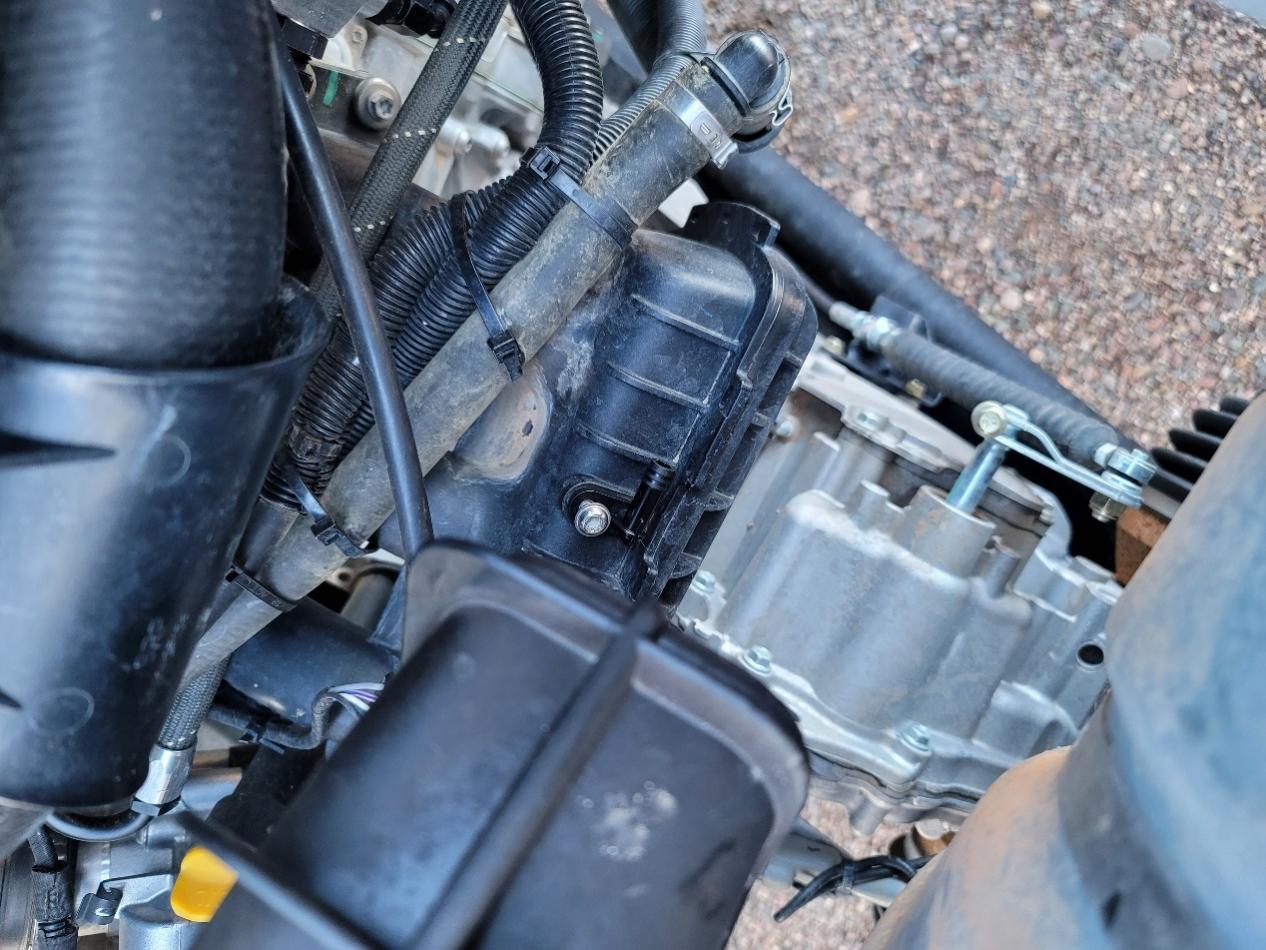 Close up of a car engine
      
      Description automatically generated